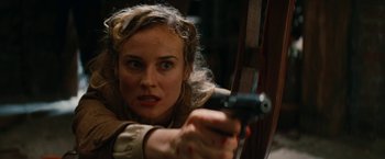 Movie still from “Inglourious Basterds” (2009), directed by Quentin Tarantino – A woman is holding a gun in her hand; Close Up shot, High angle