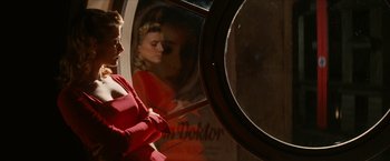 Movie still from “Inglourious Basterds” (2009), directed by Quentin Tarantino – A woman in a red dress looking in a mirror; Medium shot, Over the shoulder angle