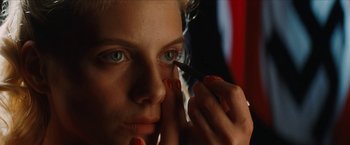 Movie still from “Inglourious Basterds” (2009), directed by Quentin Tarantino – A person putting make up on; Extreme Close Up shot, Low angle