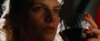 Movie still from “Inglourious Basterds” (2009), directed by Quentin Tarantino – A person holding a glass of red wine; Extreme Close Up shot, Low angle