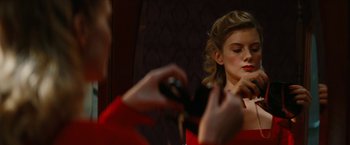 Movie still from “Inglourious Basterds” (2009), directed by Quentin Tarantino – A woman in a red dress taking a picture of another woman in a red dress; Close Up shot, Over the shoulder angle