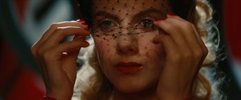 Movie still from “Inglourious Basterds” (2009), directed by Quentin Tarantino – A woman wearing a veil and red lipstick; Close Up shot, Over the shoulder angle