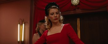 Movie still from “Inglourious Basterds” (2009), directed by Quentin Tarantino – A woman in a red dress and a black hat; Close Up shot, Low angle