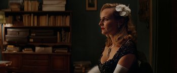 Movie still from “Inglourious Basterds” (2009), directed by Quentin Tarantino – A woman with a flower in her hair looking to the side; Close Up shot, Over the shoulder angle