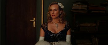 Movie still from “Inglourious Basterds” (2009), directed by Quentin Tarantino – A woman in a black and white dress with a white flower in her hair; Close Up shot, Low angle