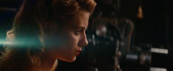 Movie still from “Inglourious Basterds” (2009), directed by Quentin Tarantino – A person's face in a dark room; Close Up shot, Low angle