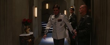 Movie still from “Inglourious Basterds” (2009), directed by Quentin Tarantino – A man in a uniform walking down a hall way; Medium shot, Low angle