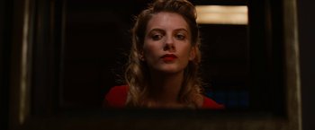 Movie still from “Inglourious Basterds” (2009), directed by Quentin Tarantino – A beautiful woman with red lipstick looking at the camera; Close Up shot, Low angle
