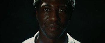 Movie still from “Inglourious Basterds” (2009), directed by Quentin Tarantino – A man's face in the dark; Extreme Close Up shot, Low angle