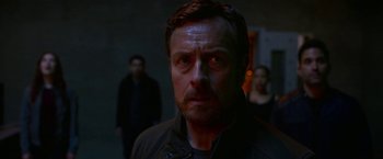 Movie still from “Lost in Space” (2018), created by Irwin Allen – A person wearing a black jacket; Close Up shot, Over the shoulder angle