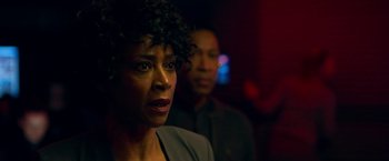 Movie still from “Lost in Space” (2018), created by Irwin Allen – A woman standing next to a man in a dark room; Close Up shot, Over the shoulder angle