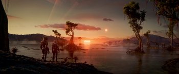 Movie still from “Lost in Space” (2018), created by Irwin Allen – A man standing next to a body of water at sunset; Extreme Wide shot, Over the shoulder angle