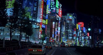 Movie still from “Lost in Translation” (2003), directed by Sofia Coppola – A city street filled with lots of traffic at night time; Extreme Wide shot, High angle
