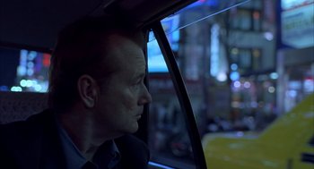 Movie still from “Lost in Translation” (2003), directed by Sofia Coppola – A man sitting in a car looking out of the window; Close Up shot, High angle