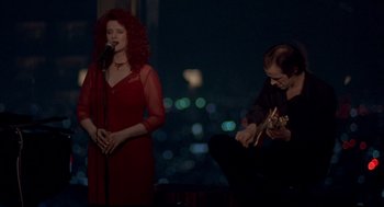 Movie still from “Lost in Translation” (2003), directed by Sofia Coppola – A man and a woman singing in front of a microphone; Wide shot, Low angle