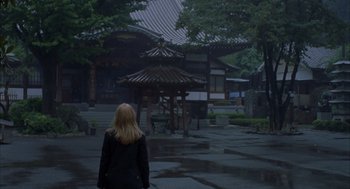 Movie still from “Lost in Translation” (2003), directed by Sofia Coppola – A woman standing in the middle of a street; Wide shot, High angle