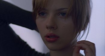 Movie still from “Lost in Translation” (2003), directed by Sofia Coppola – A woman's face in a dark room; Close Up shot, Low angle
