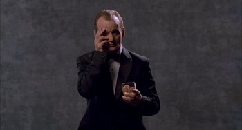 Movie still from “Lost in Translation” (2003), directed by Sofia Coppola – A man in a tuxedo holding a glass of wine; Medium shot, Low angle