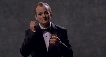 Movie still from “Lost in Translation” (2003), directed by Sofia Coppola – A man in a tuxedo holding a glass of whiskey; Close Up shot, Low angle