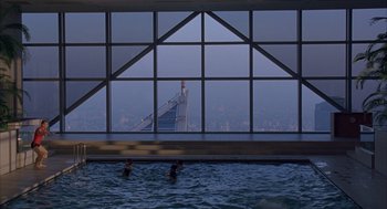 Movie still from “Lost in Translation” (2003), directed by Sofia Coppola – Two people swimming in an indoor swimming pool; Extreme Wide shot, High angle