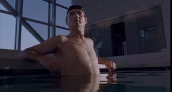 Movie still from “Lost in Translation” (2003), directed by Sofia Coppola – A man standing in a pool of water; Medium shot, Low angle