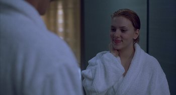 Movie still from “Lost in Translation” (2003), directed by Sofia Coppola – A woman in a white bathrobe looking in the mirror; Close Up shot, Over the shoulder angle