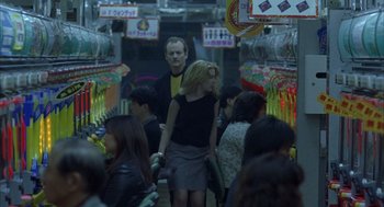 Movie still from “Lost in Translation” (2003), directed by Sofia Coppola – A group of people walking down a crowded street; Medium shot, Over the shoulder angle