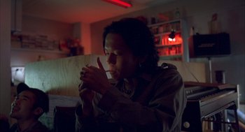 Movie still from “Lost in Translation” (2003), directed by Sofia Coppola – A man is holding his hand up to his mouth; Close Up shot, Low angle