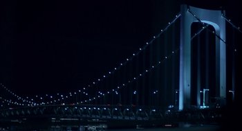 Movie still from “Lost in Translation” (2003), directed by Sofia Coppola – A large bridge lit up at night with lights; Extreme Wide shot, Low angle