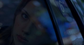 Movie still from “Lost in Translation” (2003), directed by Sofia Coppola – A woman's face in a car window; Close Up shot, Over the shoulder angle
