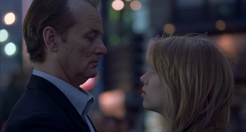 Movie still from “Lost in Translation” (2003), directed by Sofia Coppola – A man and a woman face to face in the street; Close Up shot, Low angle