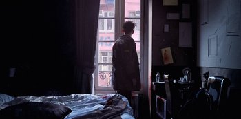 Movie still from “Love, Death & Robots” (2019), created by Tim Miller – A man standing in front of a window in a room; Wide shot, Low angle
