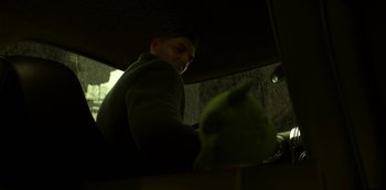 Movie still from “Love, Death & Robots” (2019), created by Tim Miller – A man sitting at a table with a parrot on top of it; Close Up shot, Low angle