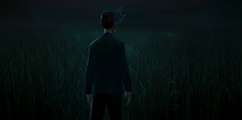 Movie still from “Love, Death & Robots” (2019), created by Tim Miller – A man in a suit standing in a field at night; Medium shot, Over the shoulder angle