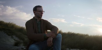 Movie still from “Love, Death & Robots” (2019), created by Tim Miller – A man sitting on the ground with his arms crossed; Close Up shot, Low angle