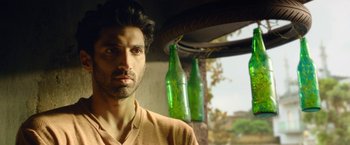 A person with two green beer bottles