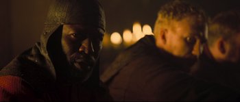 Movie still from “Kingdom of Heaven” (2005), directed by Ridley Scott – A man with a beard is looking into the camera; Close Up shot, Over the shoulder angle