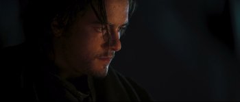 Movie still from “Kingdom of Heaven” (2005), directed by Ridley Scott – A man's face in the dark; Close Up shot, Low angle