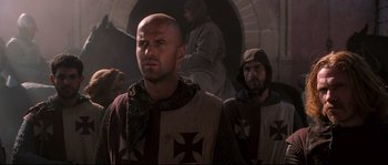 Movie still from “Kingdom of Heaven” (2005), directed by Ridley Scott – Two men in medieval garb are standing in a tunnel; Close Up shot, Over the shoulder angle