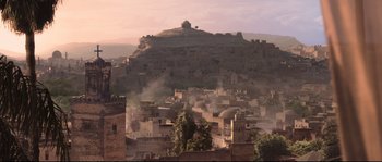Movie still from “Kingdom of Heaven” (2005), directed by Ridley Scott – A view of a city with smoke coming out of the chimney; Extreme Wide shot, High angle