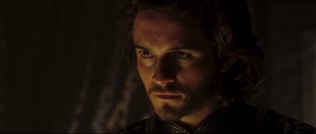 Movie still from “Kingdom of Heaven” (2005), directed by Ridley Scott – A person with a beard looking at the camera; Close Up shot, Over the shoulder angle