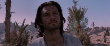 Movie still from “Kingdom of Heaven” (2005), directed by Ridley Scott – A person with long dark hair; Close Up shot, Low angle