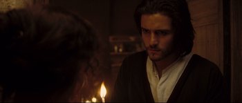 Movie still from “Kingdom of Heaven” (2005), directed by Ridley Scott – A man with long hair and a beard stares at the camera; Close Up shot, Over the shoulder angle