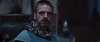 Movie still from “Kingdom of Heaven” (2005), directed by Ridley Scott – A person wearing a chain mail collar; Close Up shot, Over the shoulder angle