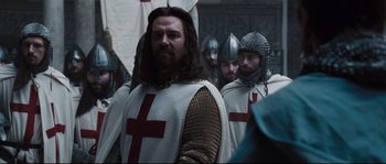 Movie still from “Kingdom of Heaven” (2005), directed by Ridley Scott – A group of men in medieval garb standing next to each other; Medium shot, Over the shoulder angle