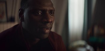 Movie still from “Lupin” (2021), created by Tigran Rosine – A person looking at the camera; Close Up shot, Over the shoulder angle