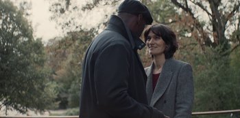 Movie still from “Lupin” (2021), created by Tigran Rosine – A man and a woman standing next to each other holding hands; Medium shot, Over the shoulder angle