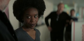 Movie still from “Lupin” (2021), created by Tigran Rosine – A person with a person in the background; Close Up shot, Over the shoulder angle