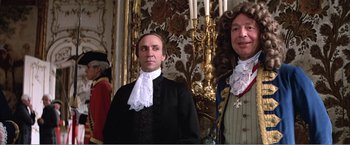 Movie still from “Amadeus” (1984), directed by Milos Forman – Two men dressed in period clothing standing next to each other; Medium shot, Low angle