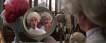 Movie still from “Amadeus” (1984), directed by Milos Forman – A mirror with a man and a woman looking in a mirror; Medium shot, Over the shoulder angle